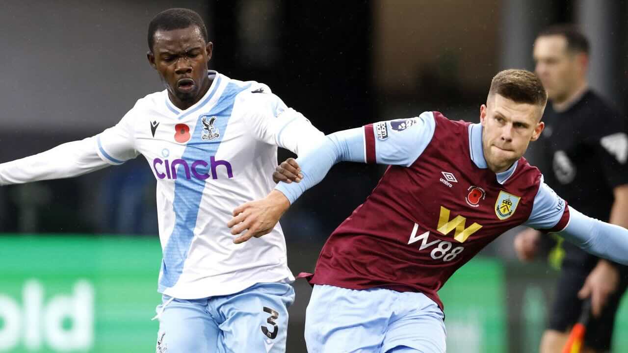 Crystal Palace defender and Burnley midfielder in a physical challenge during a Premier League match