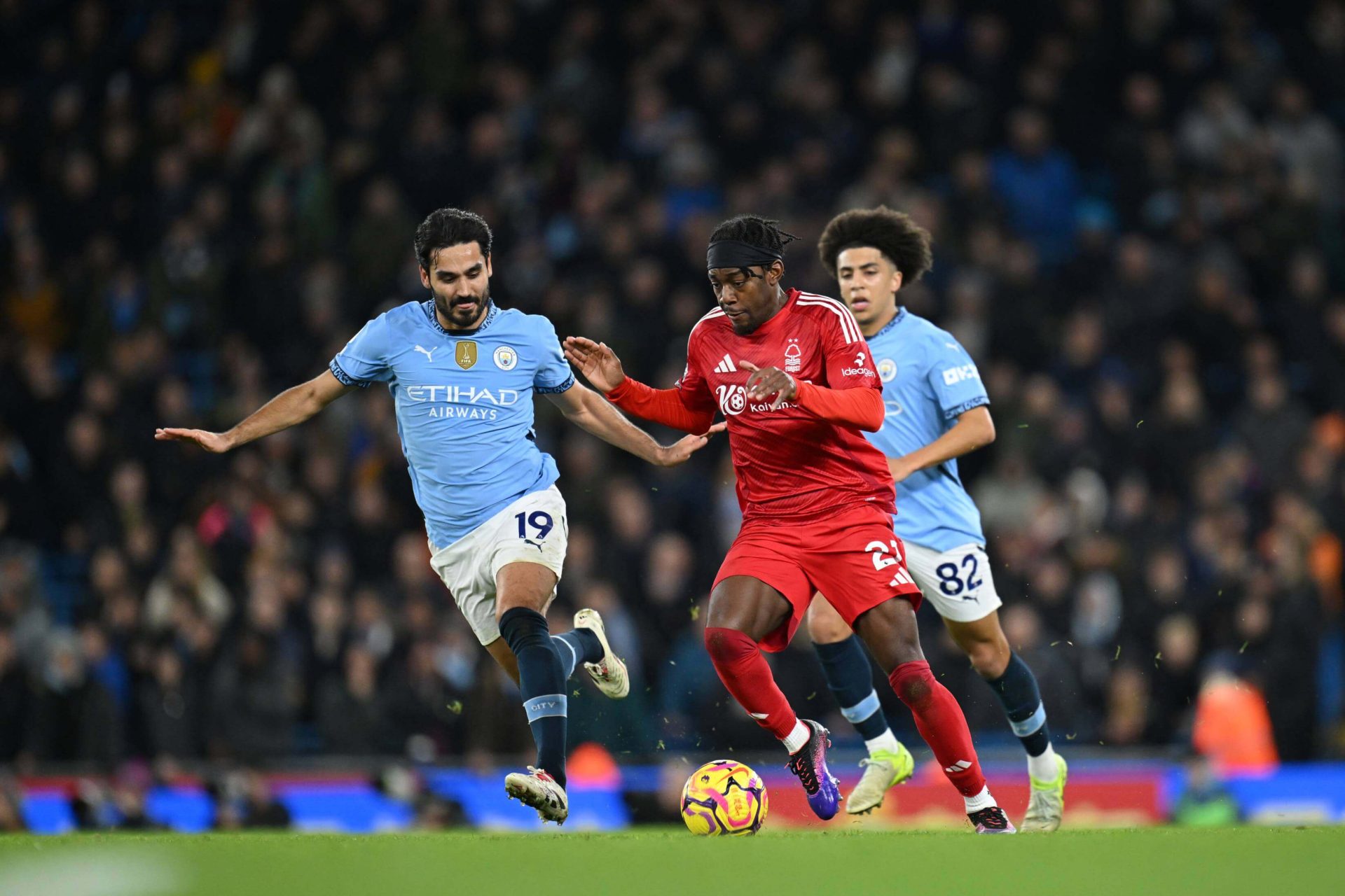 Manchester City and Nottingham Forest players compete for possession in Premier League match action