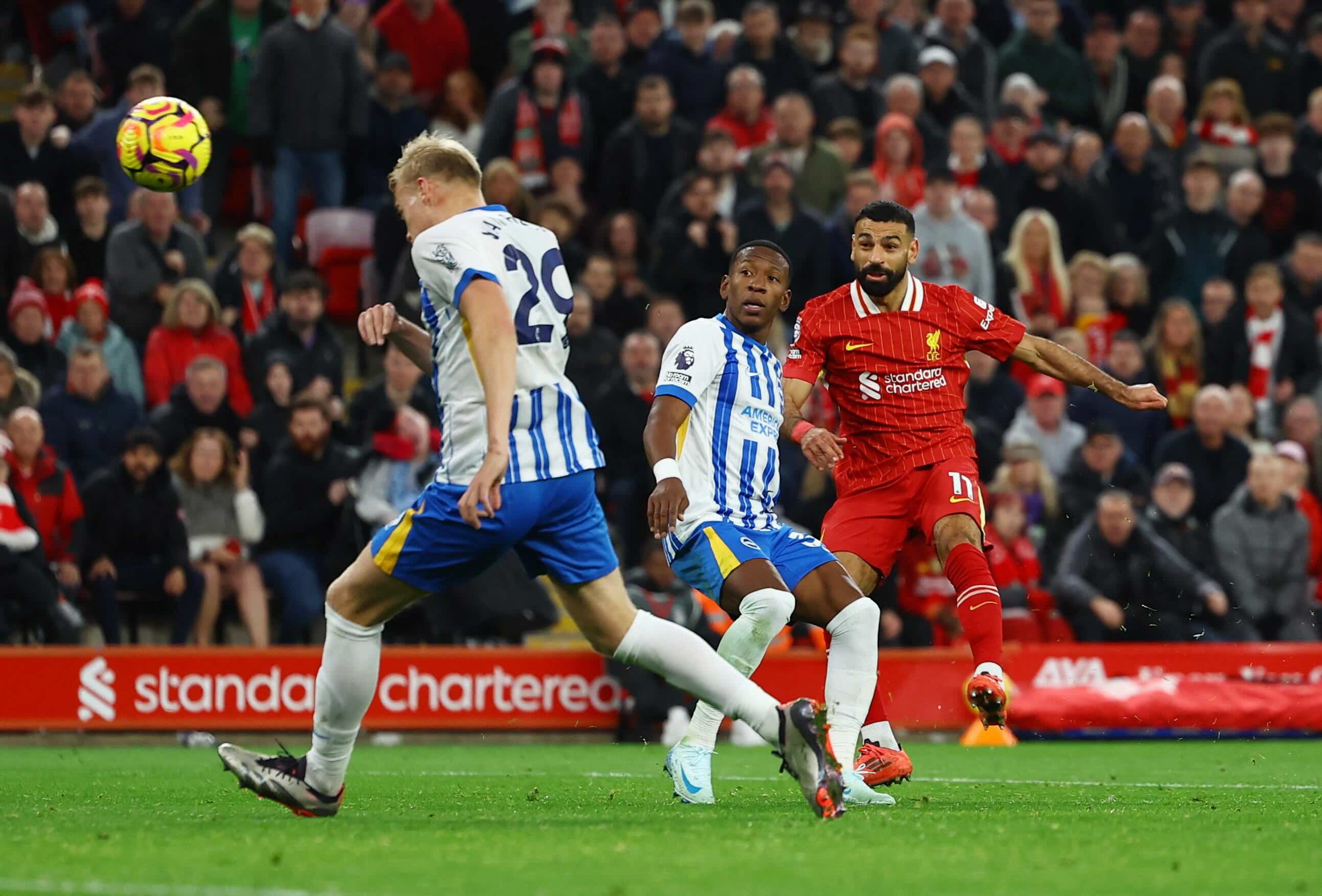 Mohamed Salah lines up a pass or shot against Brighton defenders during Liverpool vs Brighton at Anfield